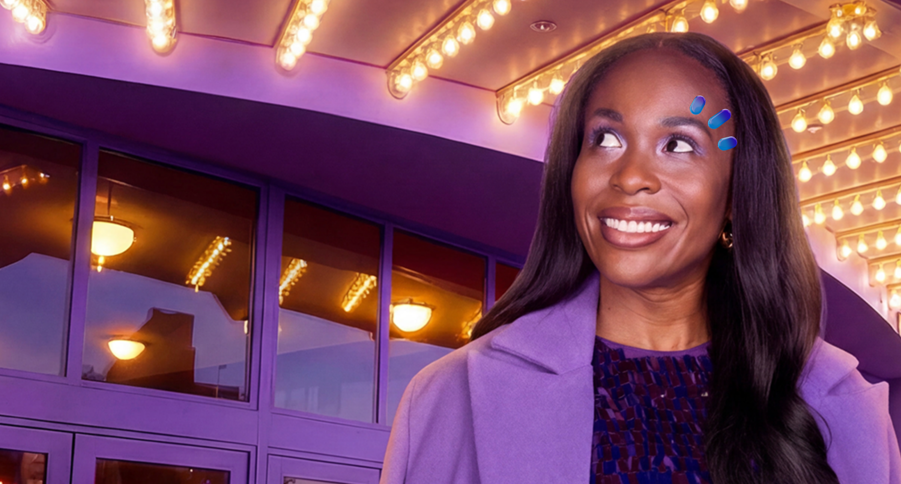 A woman sitting in a purple seat looking out the window of an airplane with purple walls