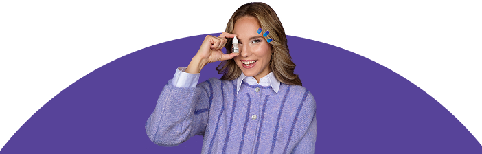 Woman in purple holding eye drops